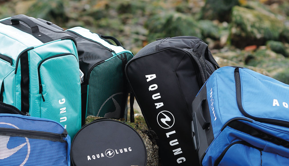 https://dev.thehonestdiver.com/wp-content/uploads/2023/02/Aqualung-Duffel-Pack-among-other-bags.jpg